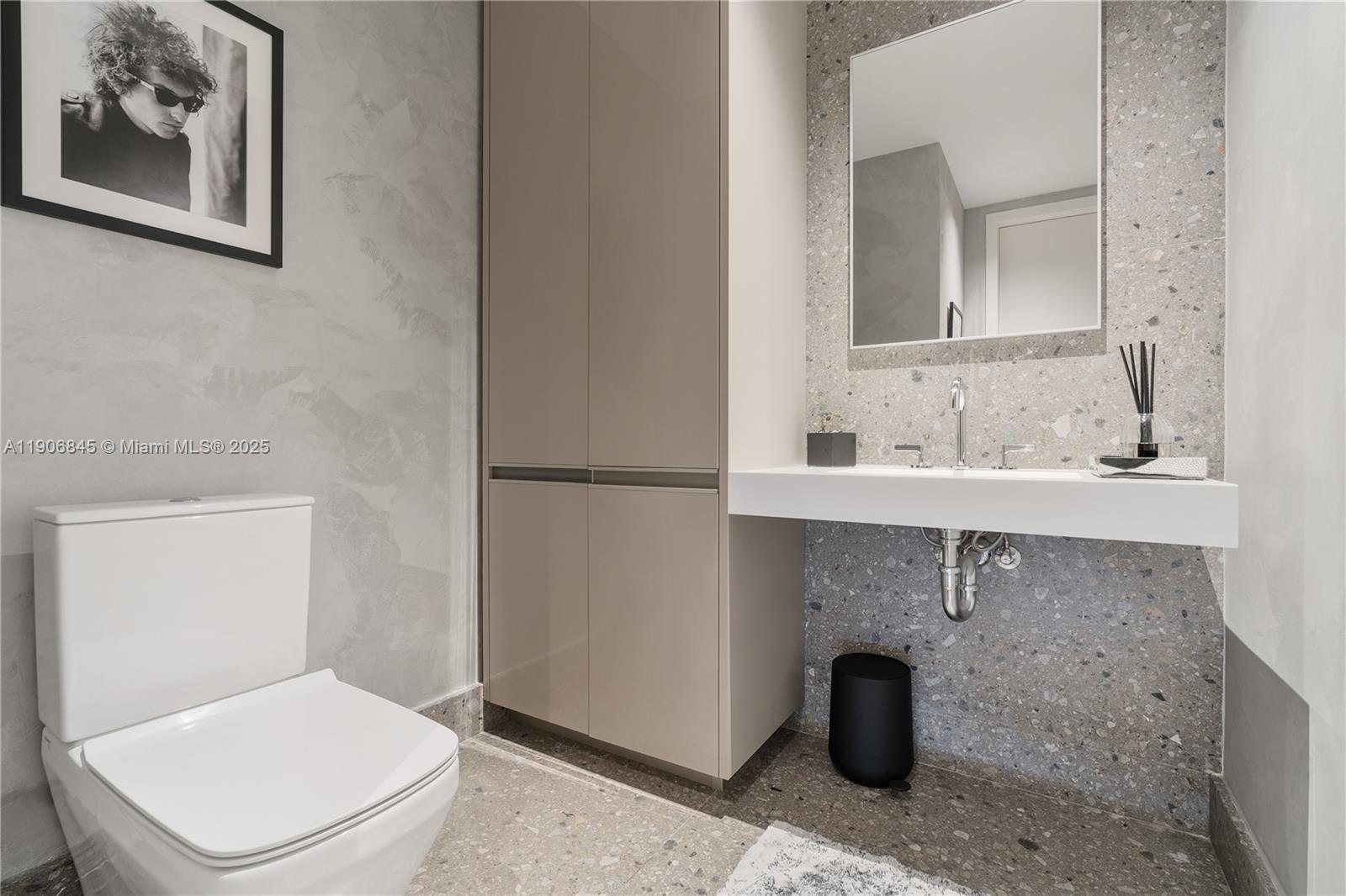 8701 Collins Avenue, Unit 1103 Miami Beach, FL 33154 - Photo 20 of 27 a bathroom with a toilet a sink and mirror