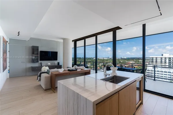 a living room with furniture tv and a large window