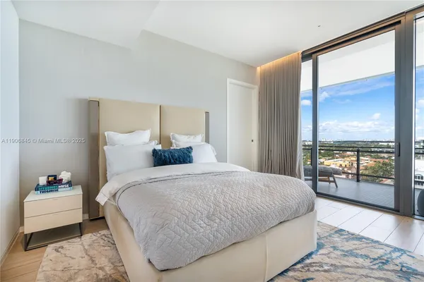 a bedroom with a large bed and a large window