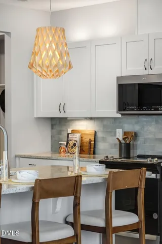 a kitchen with a sink a microwave and cabinets