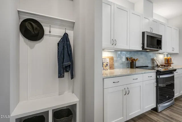 a kitchen with white cabinets and a stainless steel appliances