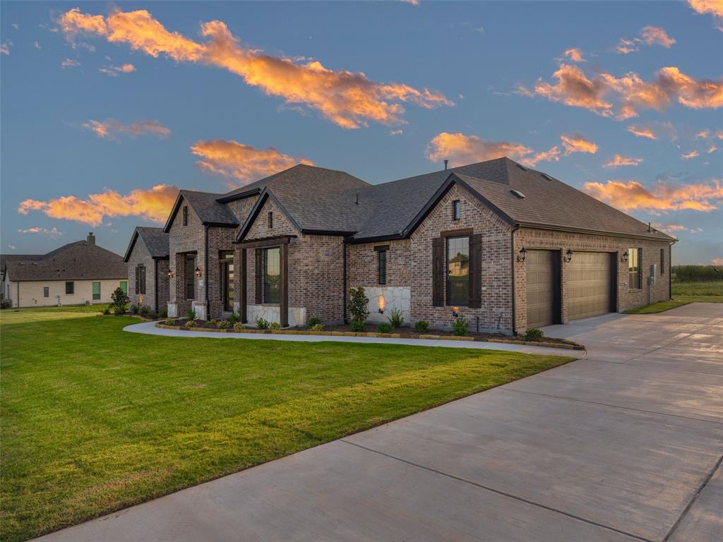 2108 Charters Circle Nevada, TX 75173 - Photo 2 of 37 French provincial home with brick siding, concrete driveway, roof with shingles, and a lawn