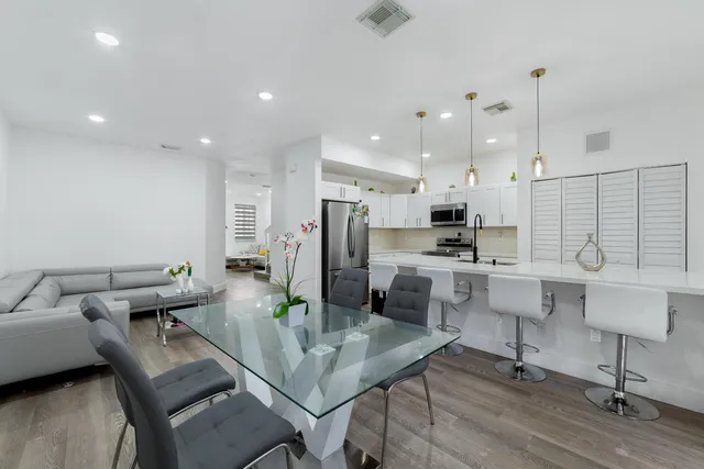 a kitchen with white cabinets and stainless steel appliances