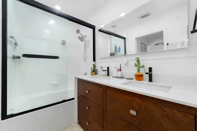 a kitchen with stainless steel appliances a sink dishwasher refrigerator and cabinets