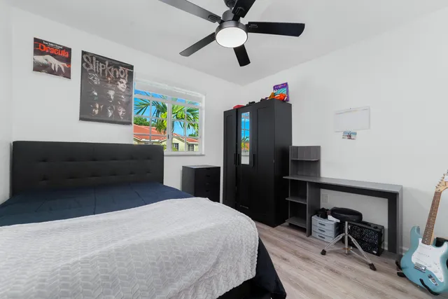 a bedroom with a bed and a dresser