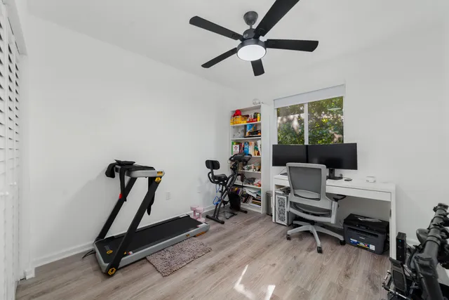 a view of a workspace with furniture and a window