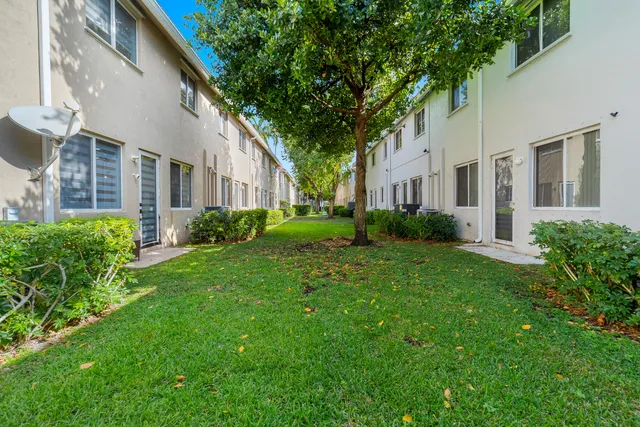 a view of a yard in front of a brick house