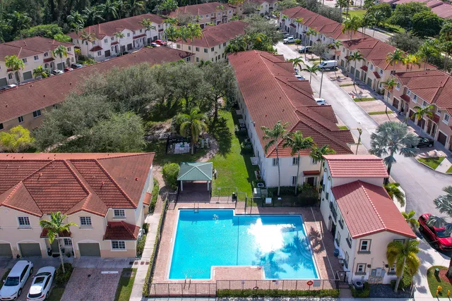 an aerial view of residential houses with outdoor space