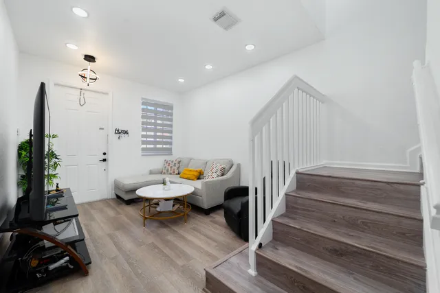 a room with wooden floor and furniture