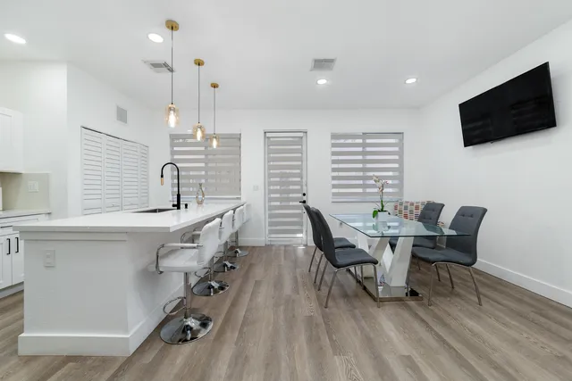 a dining room with furniture and wooden floor