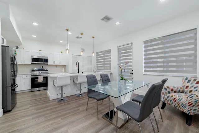 a view of a dining room with furniture and wooden floor