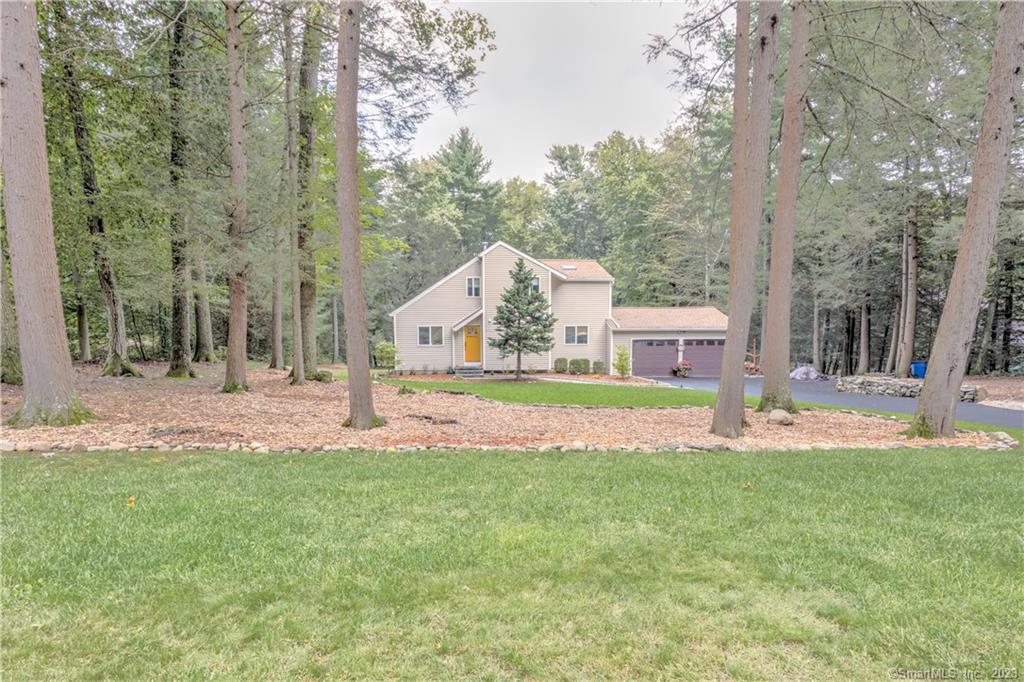a view of house with garden and trees