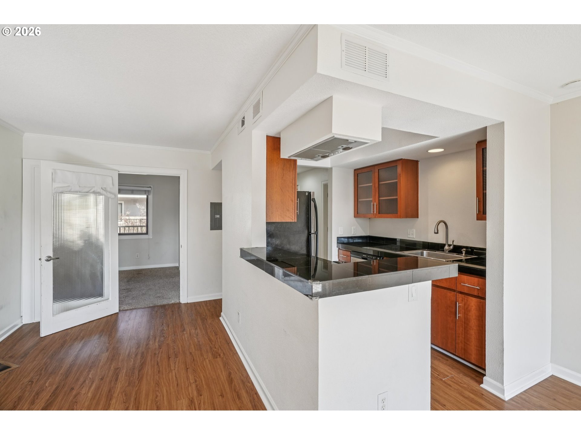 6600 Southeast Division Street, Unit 305 Portland, OR 97206 - Photo 12 of 34 a kitchen view with wooden floor and electronic appliances