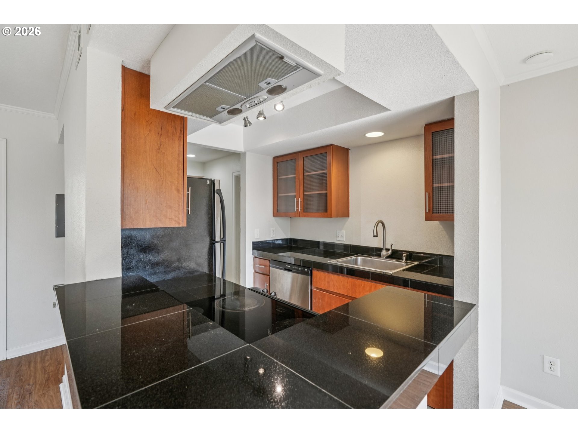 6600 Southeast Division Street, Unit 305 Portland, OR 97206 - Photo 13 of 34 a kitchen with granite countertop a refrigerator and a sink