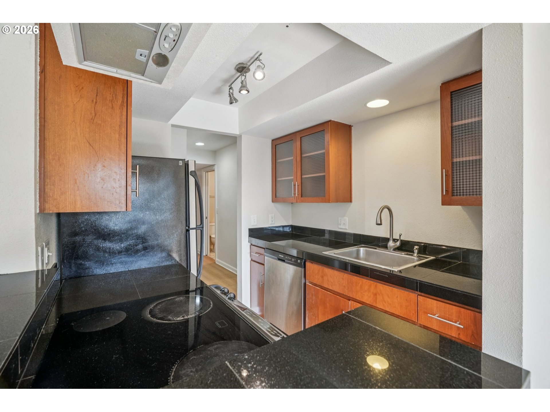 6600 Southeast Division Street, Unit 305 Portland, OR 97206 - Photo 14 of 34 a kitchen with granite countertop a sink stainless steel appliances and cabinets