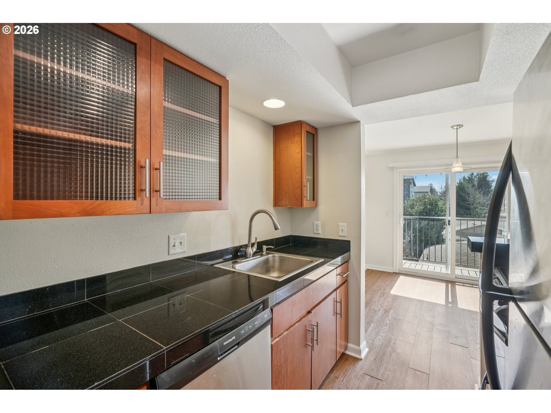 6600 Southeast Division Street, Unit 305 Portland, OR 97206 - Photo 15 of 34 a kitchen that has a sink and a wooden floor
