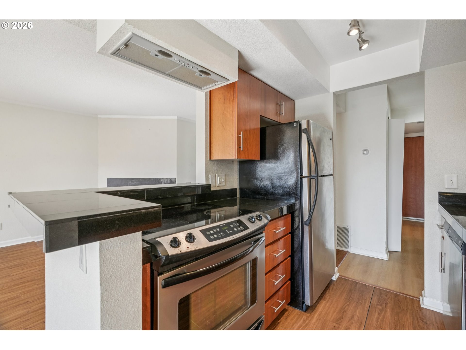 6600 Southeast Division Street, Unit 305 Portland, OR 97206 - Photo 16 of 34 a kitchen with stainless steel appliances a stove a refrigerator and a cabinets