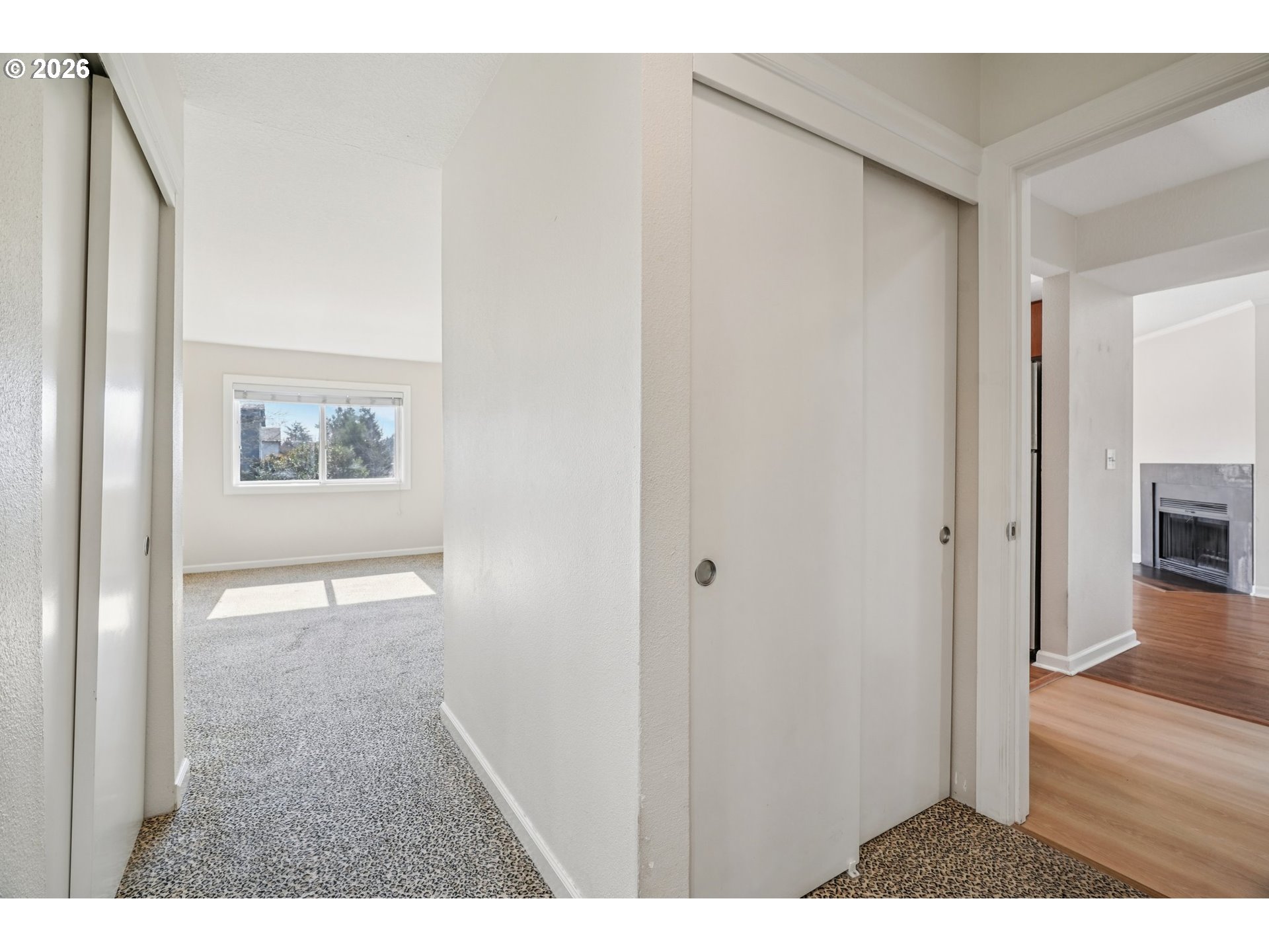 6600 Southeast Division Street, Unit 305 Portland, OR 97206 - Photo 24 of 34 a view of a hallway with wooden floor and a living room