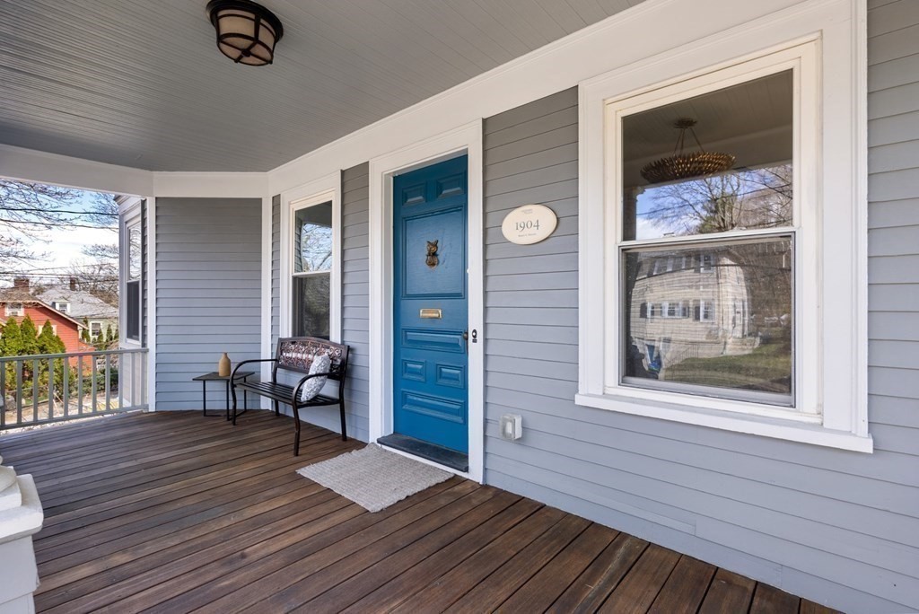 204 Langley Road Newton, MA 02459 - Photo 2 of 27 a view of a hallway with wooden floor and furniture