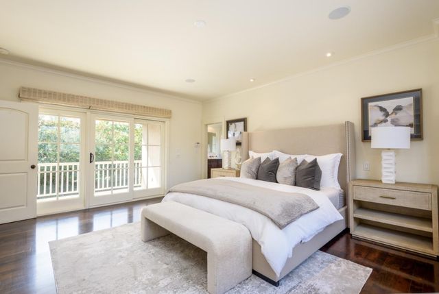 a bedroom with a large bed and a large window