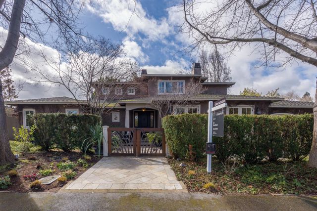 a front view of a house with garden