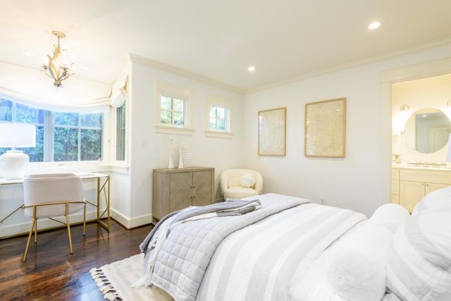 a bedroom with a bed and a chair