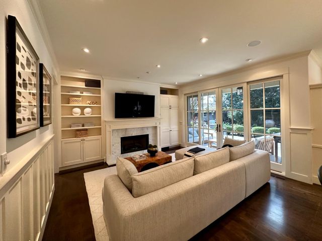 a living room with furniture fireplace and flat screen tv