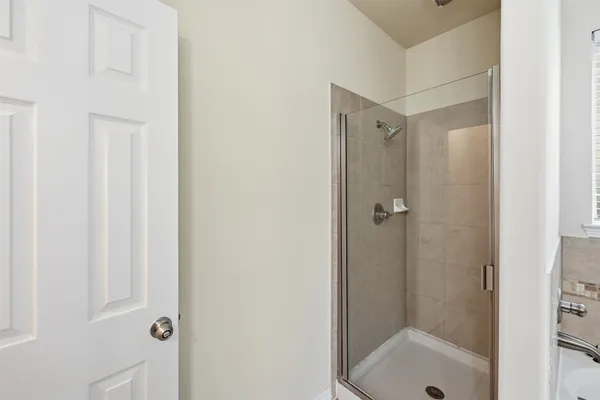 a bathroom with a double vanity sink a mirror and a bathtub