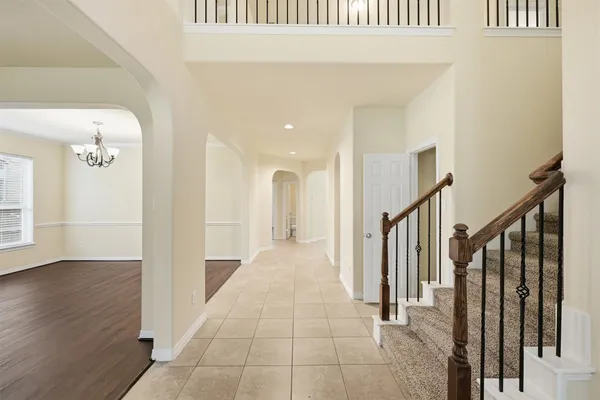 a view of a hallway with wooden floor and entryway