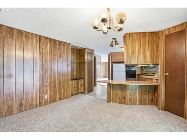 a kitchen with kitchen island granite countertop wooden cabinets and stainless steel appliances