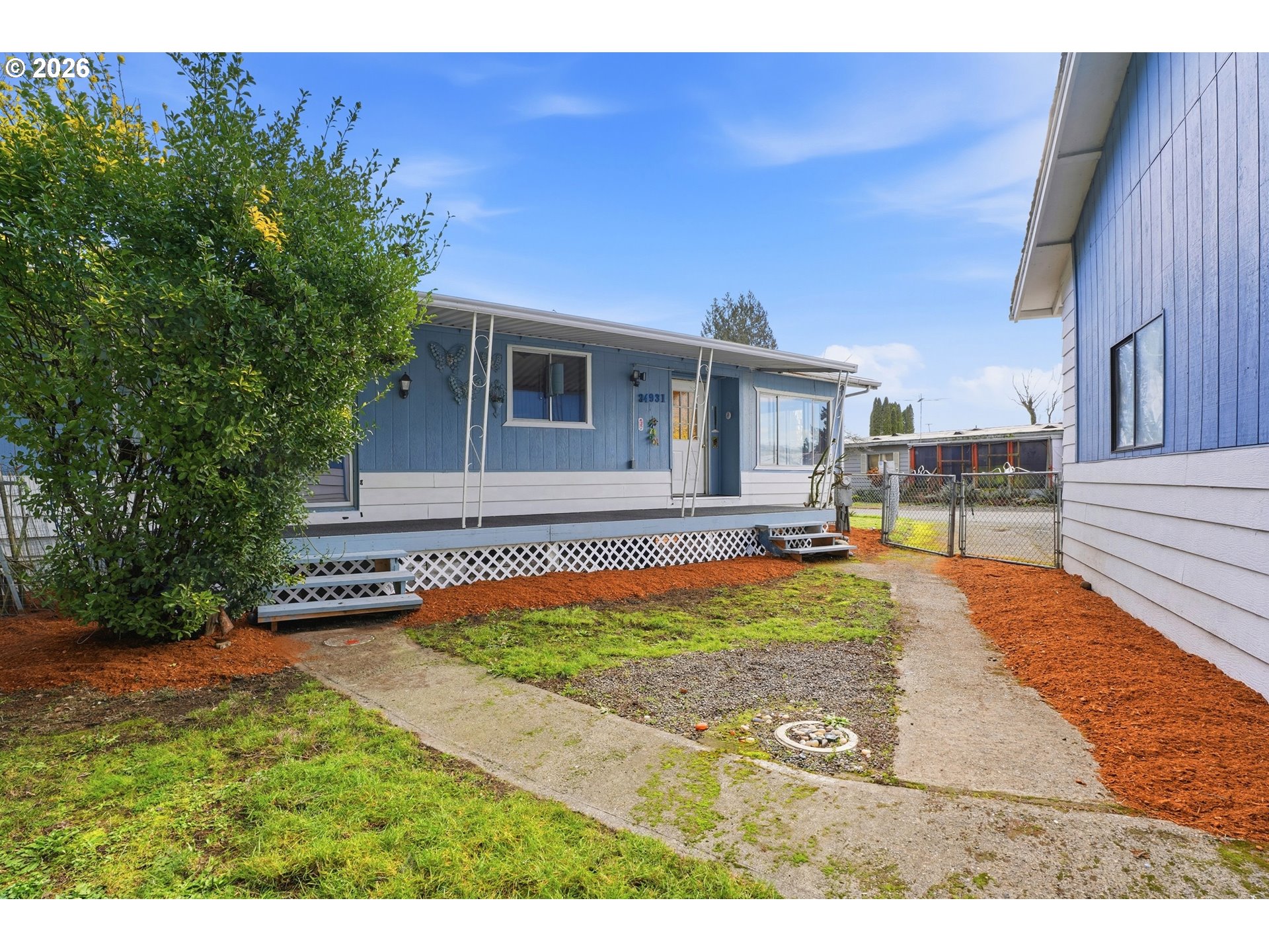 34931 Jackson Way, Unit 36 Scappoose, OR 97056 - Photo 27 of 35 a view of a house with backyard and sitting area