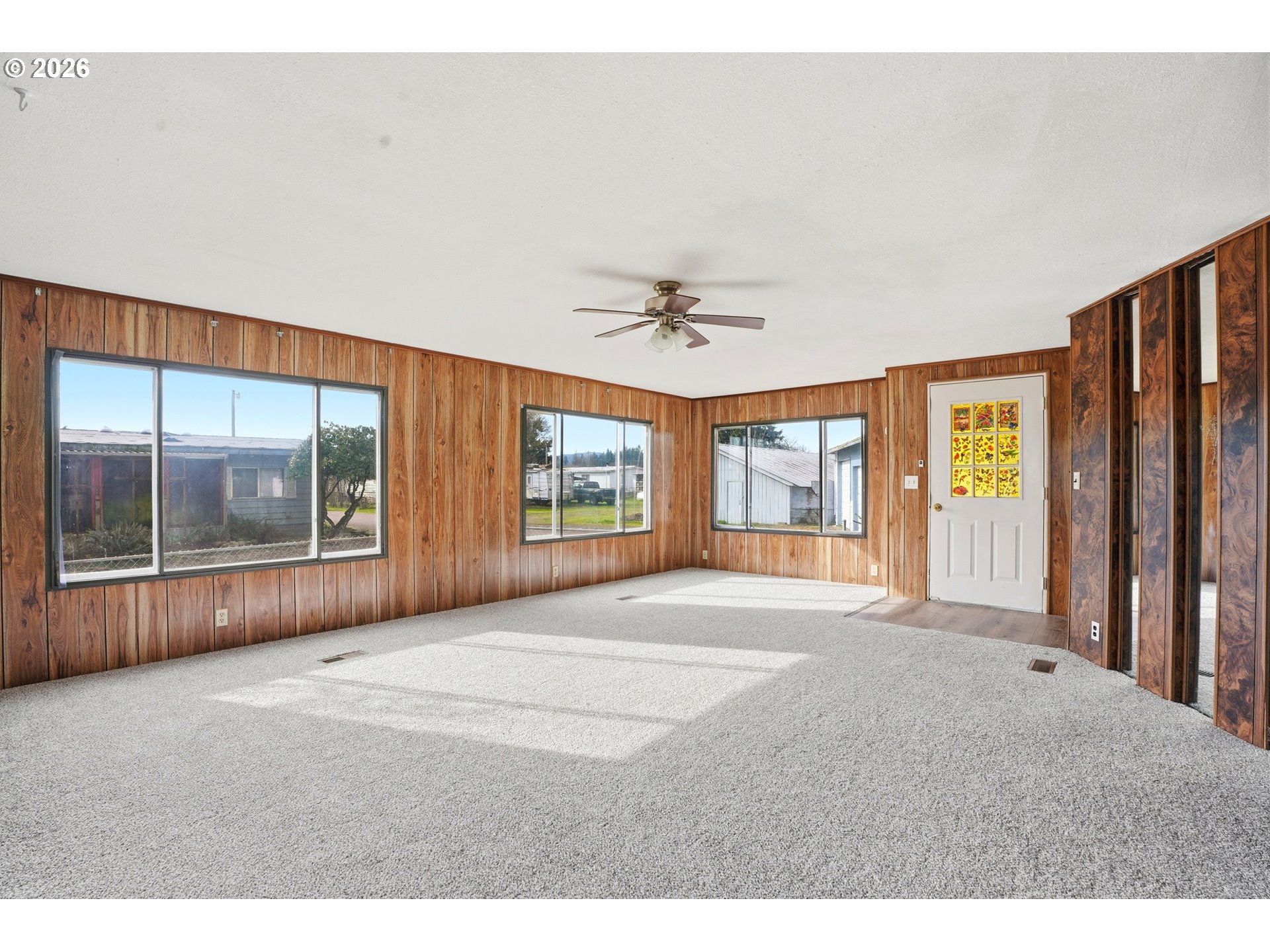 34931 Jackson Way, Unit 36 Scappoose, OR 97056 - Photo 6 of 35 a view of an empty room with a window