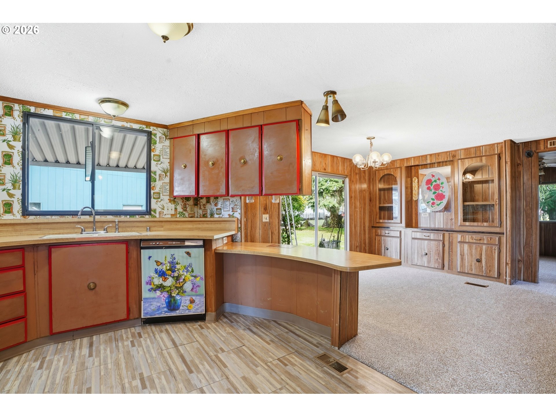 34931 Jackson Way, Unit 36 Scappoose, OR 97056 - Photo 7 of 35 a kitchen that has a lot of cabinets a sink and a wooden floor in it