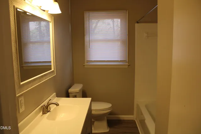 a white toilet sitting next to a white tub