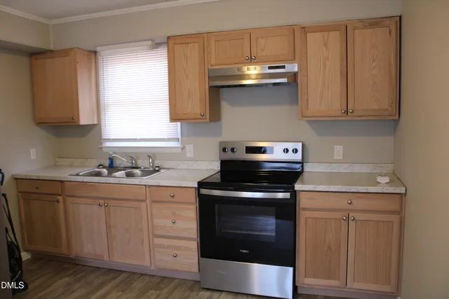 a kitchen with cabinets appliances and a sink