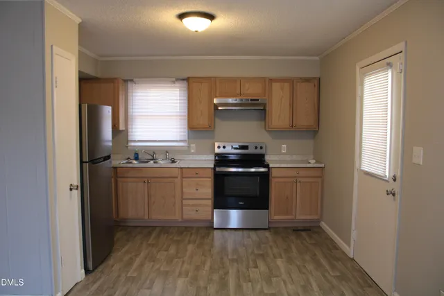 a kitchen with a sink and a stove top oven