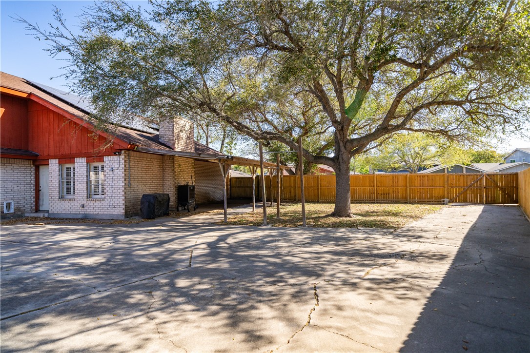 2217 Post Oak Drive Portland, TX 78374 - Photo 36 of 39 a tree in a yard next to a building
