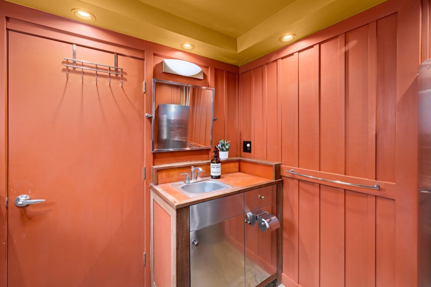 73 Mt Devon Road Carmel Highlands, CA 93923 - Photo 75 of 88 a bathroom with a sink a mirror and a shower curtain
