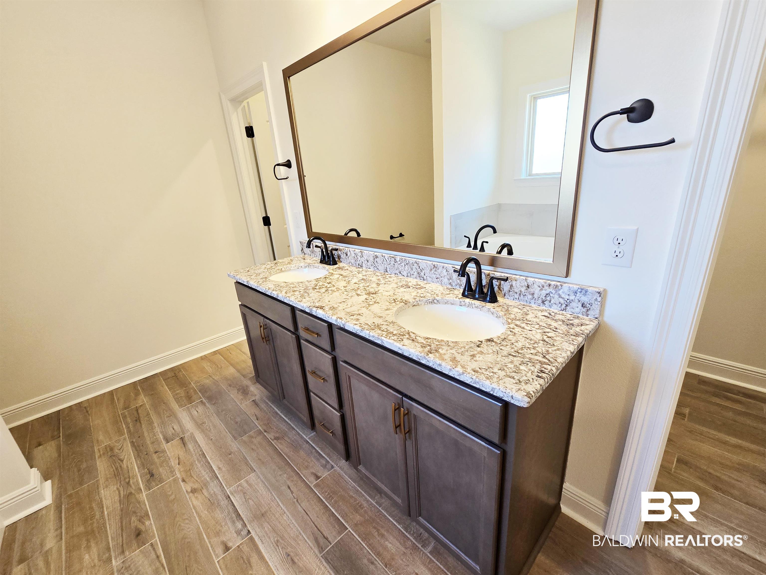 11178 Bonaventure Avenue Daphne, AL 36526 - Photo 11 of 20 Bathroom with dark wood-type flooring, double vanity, and a garden tub