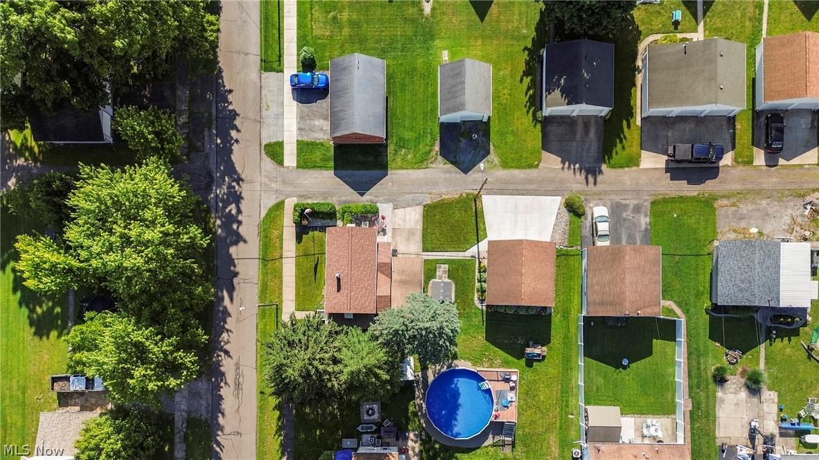 629 Clinton Street Niles, OH 44446 - Photo 46 of 50 Aerial perspective showcasing a residential street with multiple properties featuring concrete driveways, green lawns, and mature trees