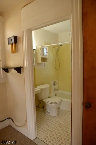 a bathroom with a shower toilet and sink