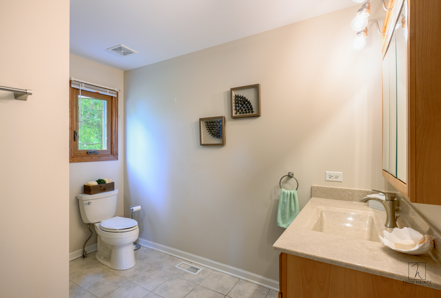 11506 Cemetery Road Capron, IL 61012 - Photo 11 of 42 a bathroom with a toilet sink and mirror