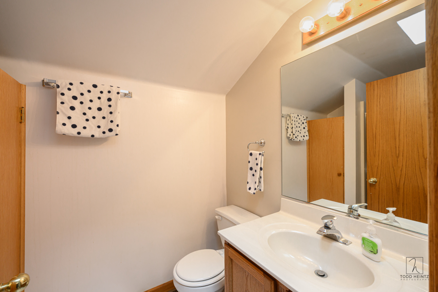 11506 Cemetery Road Capron, IL 61012 - Photo 19 of 42 a bathroom with a sink mirror vanity and toilet