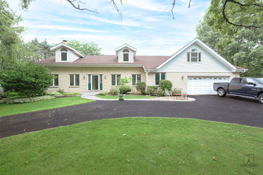 11506 Cemetery Road Capron, IL 61012 - Photo 2 of 42 a front view of a house with a yard and green space