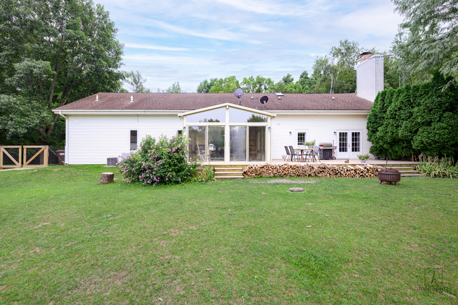 11506 Cemetery Road Capron, IL 61012 - Photo 23 of 42 a front view of a house with a garden