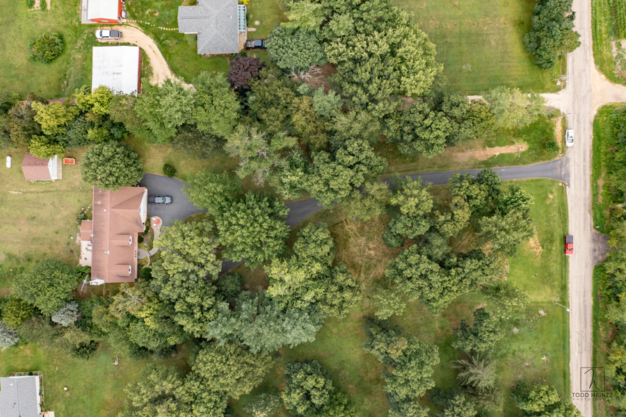 11506 Cemetery Road Capron, IL 61012 - Photo 35 of 42 an aerial view of a house with a yard lake and trees all around