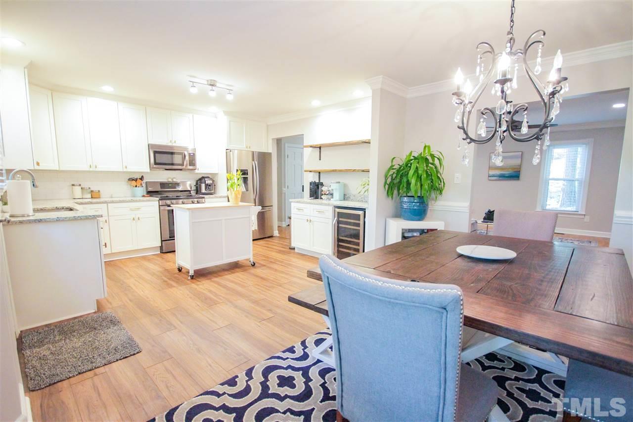 8212 Hambledon Court Raleigh, NC 27615 - Photo 2 of 28 a view of kitchen with sink refrigerator dining table and chairs