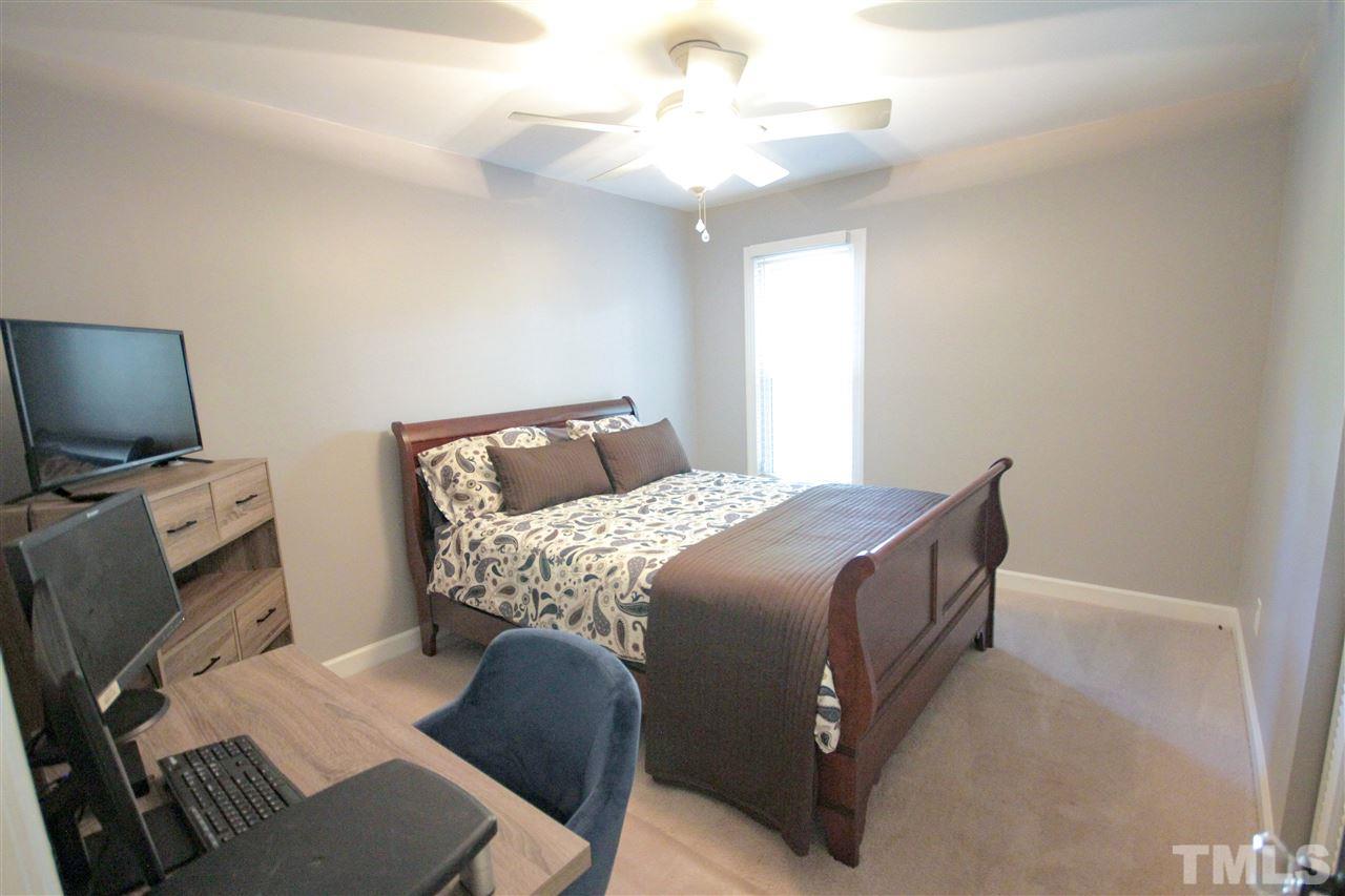 8212 Hambledon Court Raleigh, NC 27615 - Photo 11 of 28 a bedroom with a bed and a television