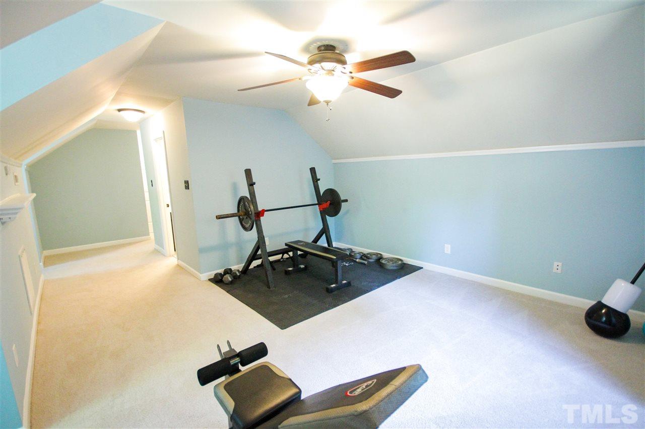 8212 Hambledon Court Raleigh, NC 27615 - Photo 14 of 28 a room with gym equipment and view of living room