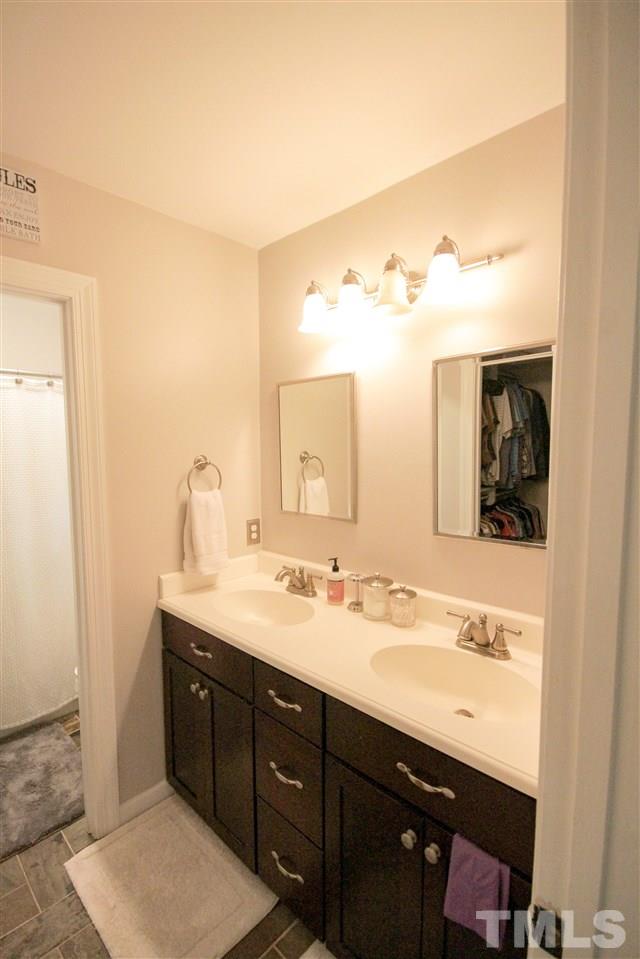 8212 Hambledon Court Raleigh, NC 27615 - Photo 15 of 28 a bathroom with a sink and a mirror